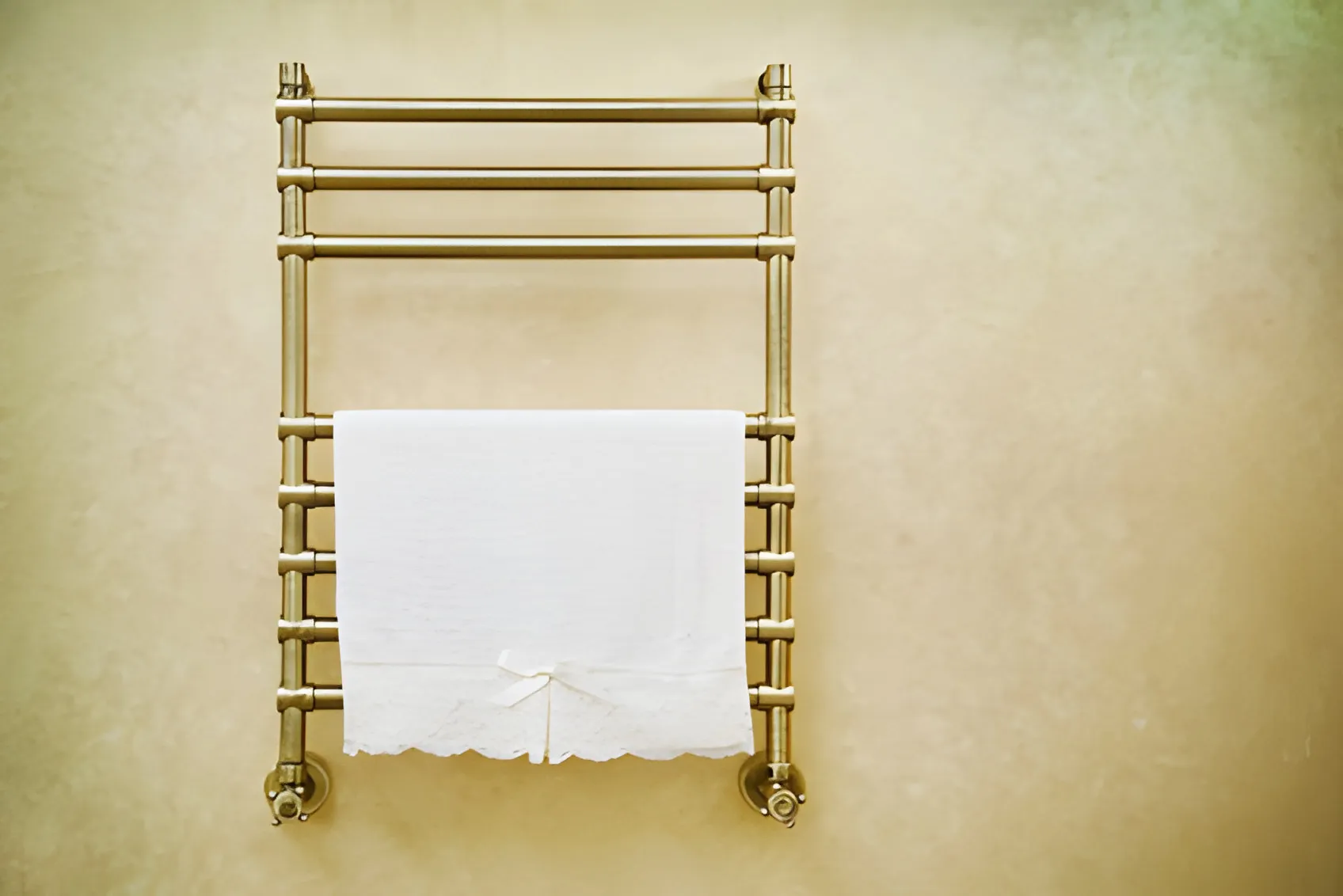 A brass heated towel rail